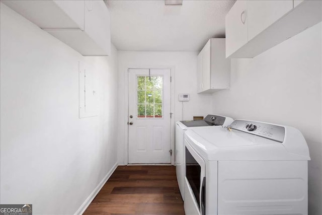 laundry area featuring cabinets, washer and dryer, and dark wood-type flooring