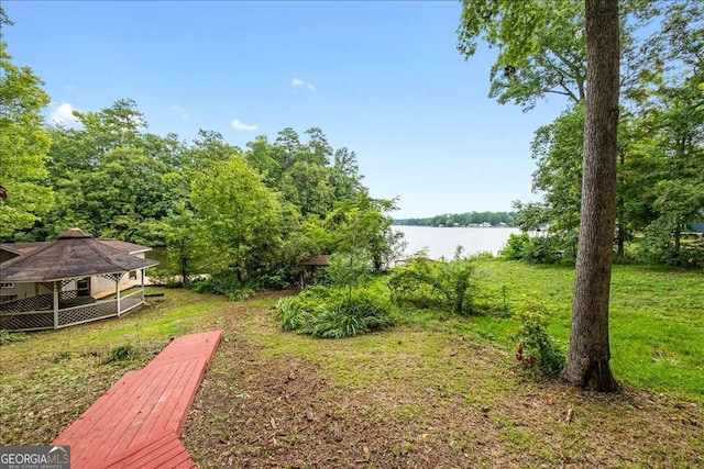 view of yard featuring a gazebo and a water view