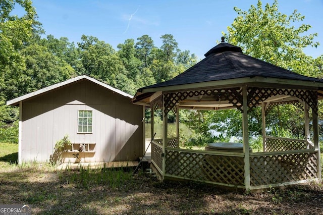 back of property with a gazebo