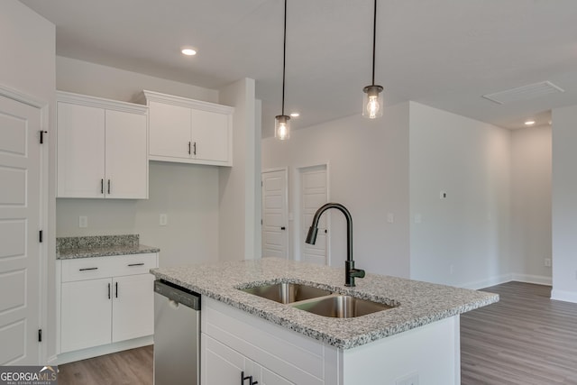 kitchen featuring a kitchen island with sink, white cabinets, sink, hanging light fixtures, and stainless steel dishwasher