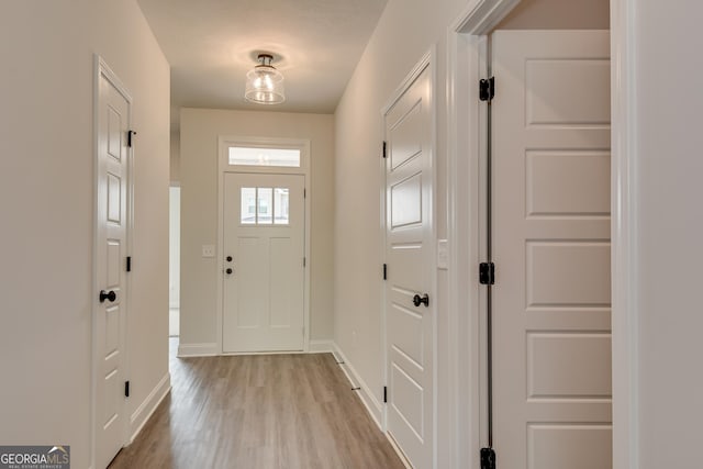 doorway to outside with light wood-type flooring