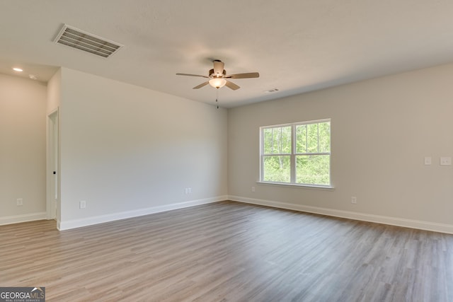 empty room with ceiling fan and light wood-type flooring