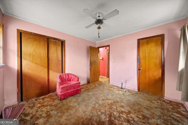 unfurnished bedroom featuring ceiling fan, a closet, carpet floors, and ornamental molding