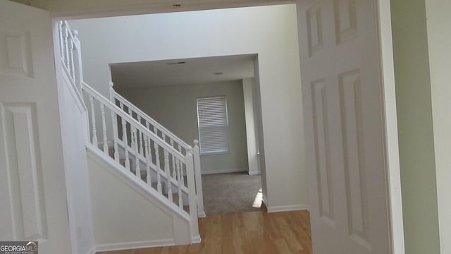 stairway with hardwood / wood-style floors