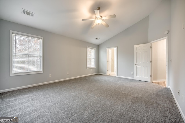 carpeted empty room with high vaulted ceiling and ceiling fan