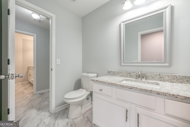 bathroom with vanity and toilet