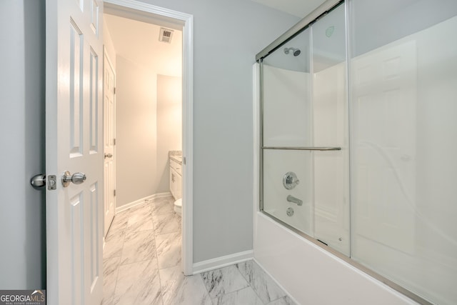 bathroom with vanity and bath / shower combo with glass door