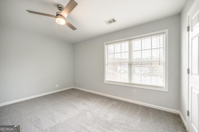 spare room featuring ceiling fan and carpet