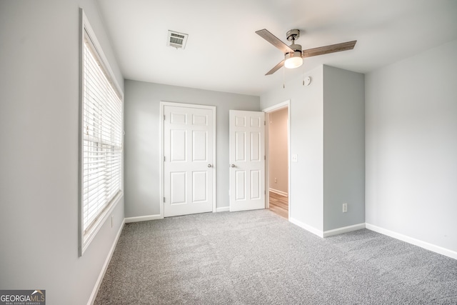 unfurnished bedroom featuring carpet and ceiling fan