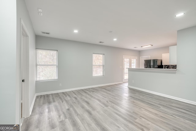 unfurnished living room with light hardwood / wood-style flooring