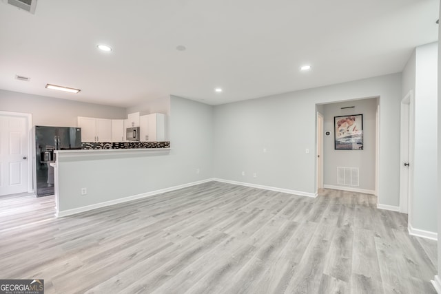 unfurnished living room with light hardwood / wood-style floors