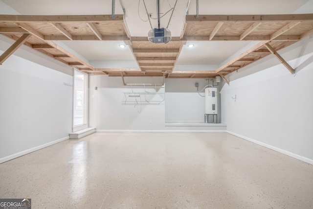 garage with a garage door opener and electric water heater