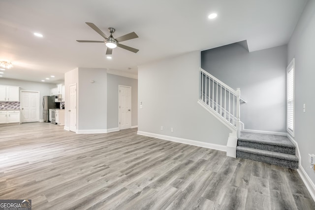 unfurnished living room with ceiling fan and light hardwood / wood-style flooring