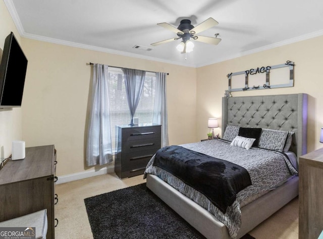 carpeted bedroom with ceiling fan and crown molding