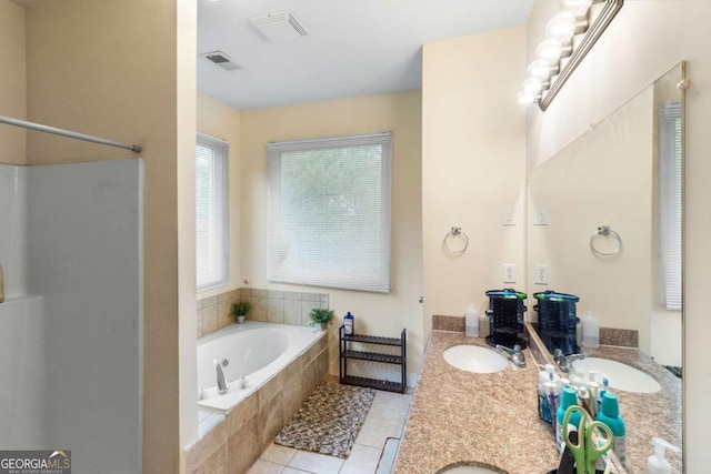 bathroom featuring tile patterned flooring, shower with separate bathtub, and vanity