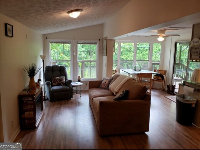 hall with dark hardwood / wood-style floors, lofted ceiling, cooling unit, a barn door, and a textured ceiling