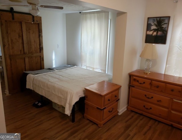 bedroom featuring ceiling fan and dark hardwood / wood-style flooring