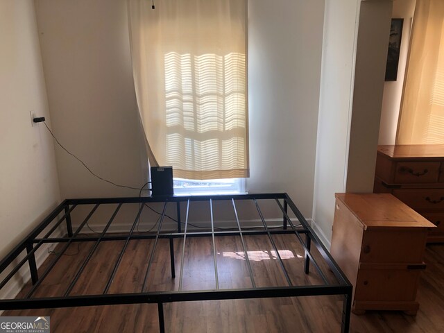 bedroom with dark hardwood / wood-style floors and ceiling fan