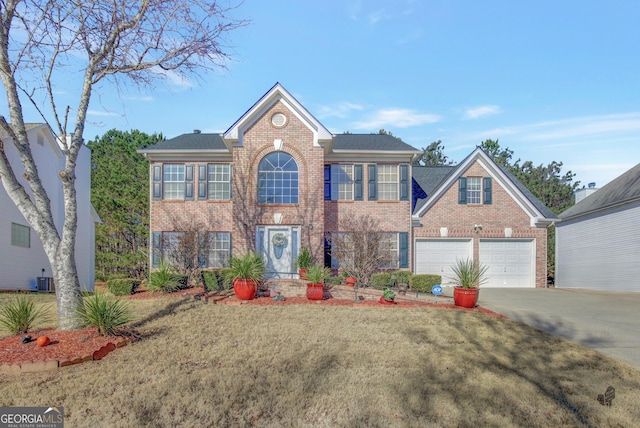 colonial-style house with a front yard, a garage, and central AC unit