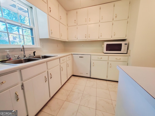 kitchen with sink, white cabinets, and white appliances