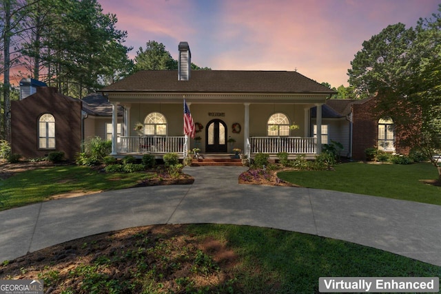 view of front of house featuring a yard and a porch