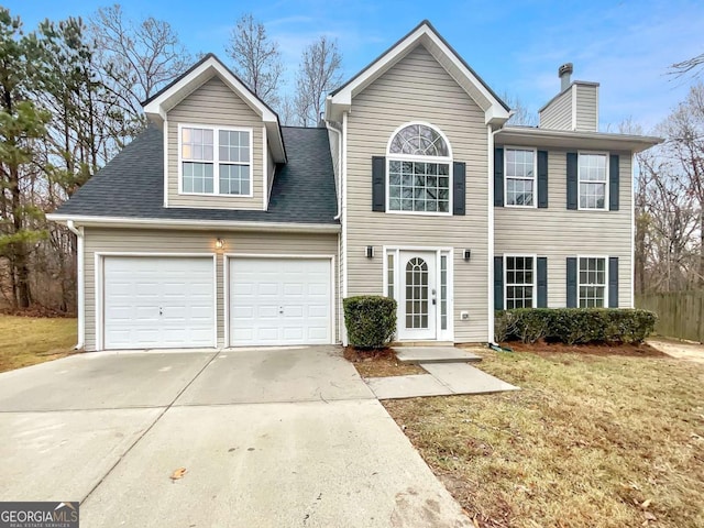 view of front of property with a front yard and a garage