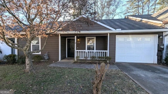 ranch-style house featuring a garage and covered porch