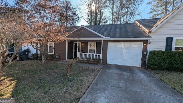 ranch-style house featuring covered porch, a garage, and a front lawn