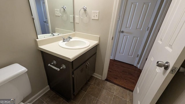 bathroom with tile patterned flooring, vanity, and toilet