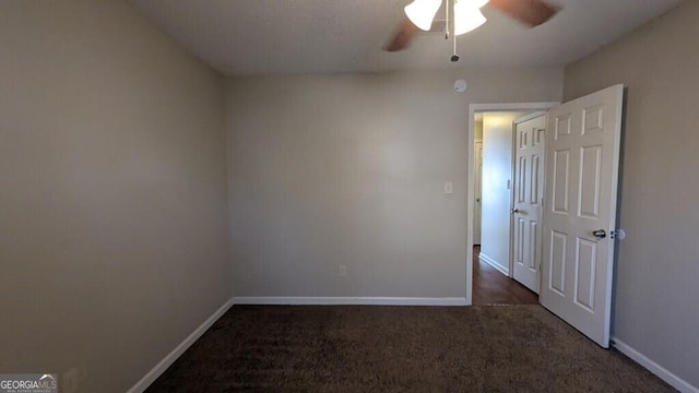 unfurnished room with ceiling fan and dark colored carpet