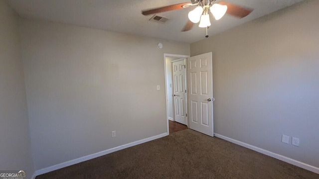 carpeted spare room featuring ceiling fan