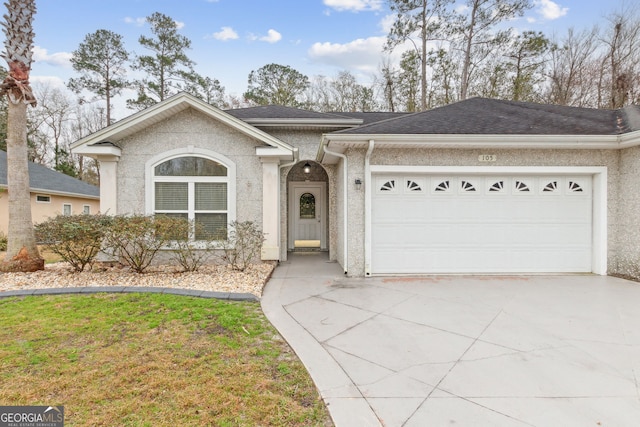 ranch-style house with a garage, a shingled roof, concrete driveway, and stucco siding