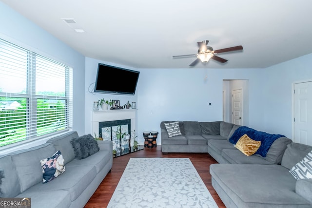 living room with dark hardwood / wood-style floors and ceiling fan