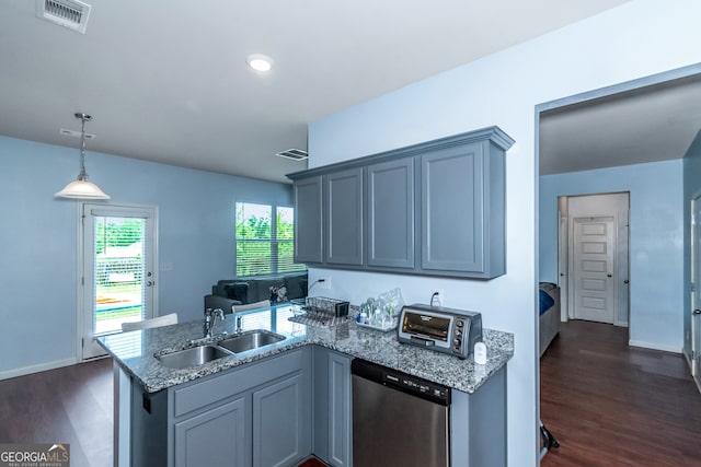 kitchen with dishwasher, pendant lighting, dark hardwood / wood-style floors, and sink