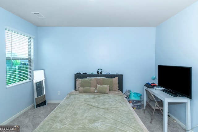 bedroom featuring light colored carpet