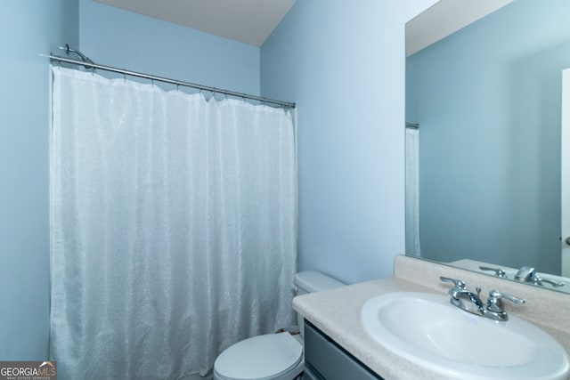 bathroom with a shower with curtain, vanity, and toilet