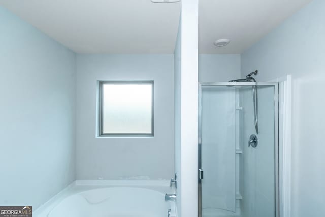 bathroom with shower with separate bathtub