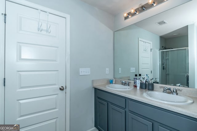 bathroom featuring vanity and a shower with shower door