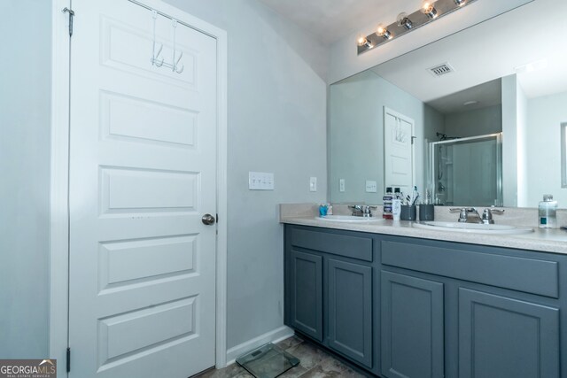 bathroom featuring vanity and a shower with door