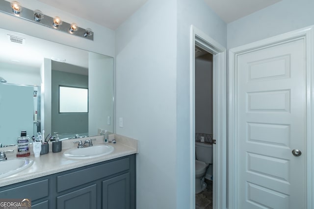 bathroom featuring vanity and toilet