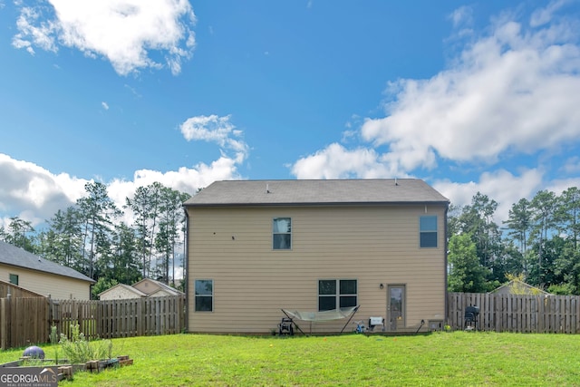 back of house featuring a yard