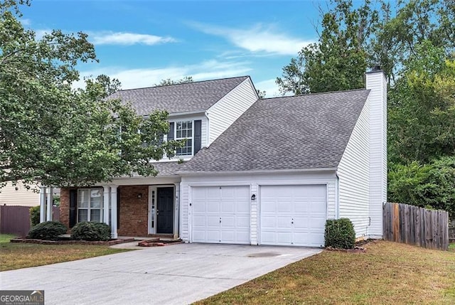 view of front of property featuring a front lawn and a garage