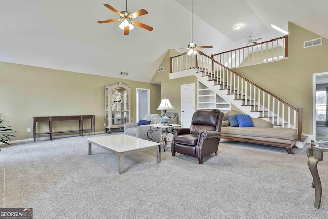 living room with high vaulted ceiling and light colored carpet