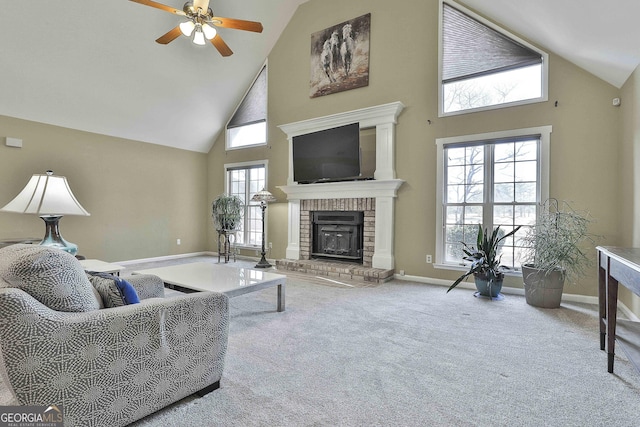 living room featuring ceiling fan, high vaulted ceiling, a healthy amount of sunlight, and a brick fireplace