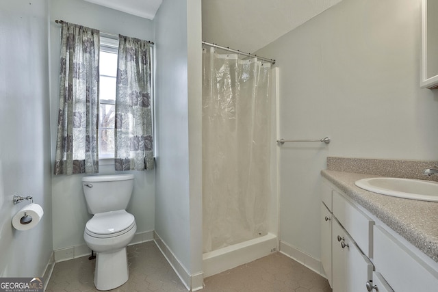 bathroom featuring tile patterned floors, curtained shower, vanity, and toilet