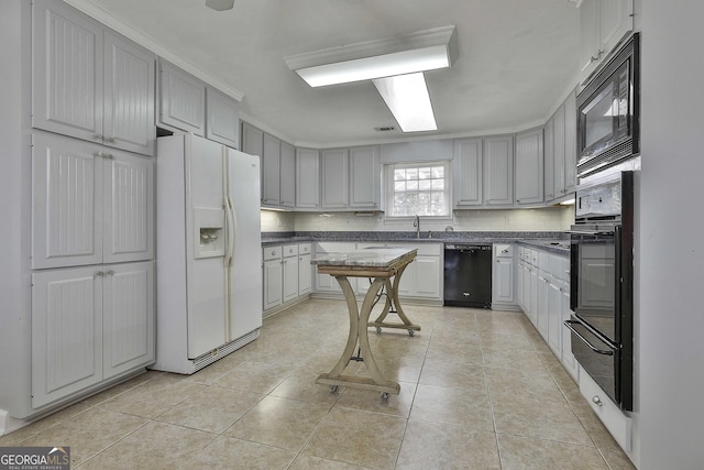 kitchen featuring decorative backsplash, light tile patterned floors, gray cabinets, and black appliances