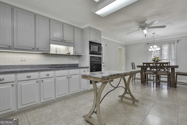 kitchen featuring black appliances, ceiling fan with notable chandelier, crown molding, tasteful backsplash, and decorative light fixtures