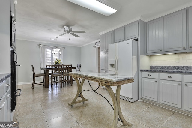 kitchen with white refrigerator with ice dispenser, crown molding, gray cabinets, decorative backsplash, and ceiling fan with notable chandelier