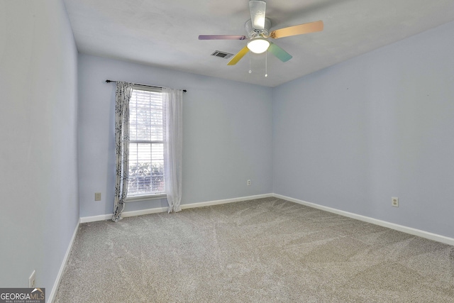 unfurnished room featuring ceiling fan and carpet floors