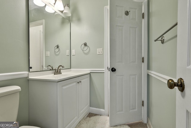 bathroom featuring vanity and toilet